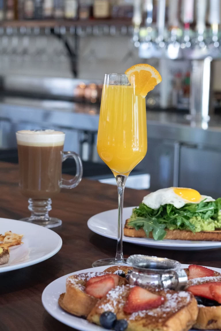 Drinks on a table with eggs and French toast