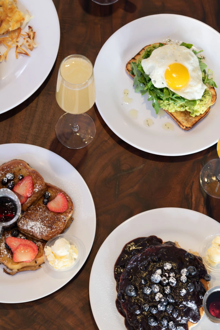 Plates of French toast, pancakes, and eggs