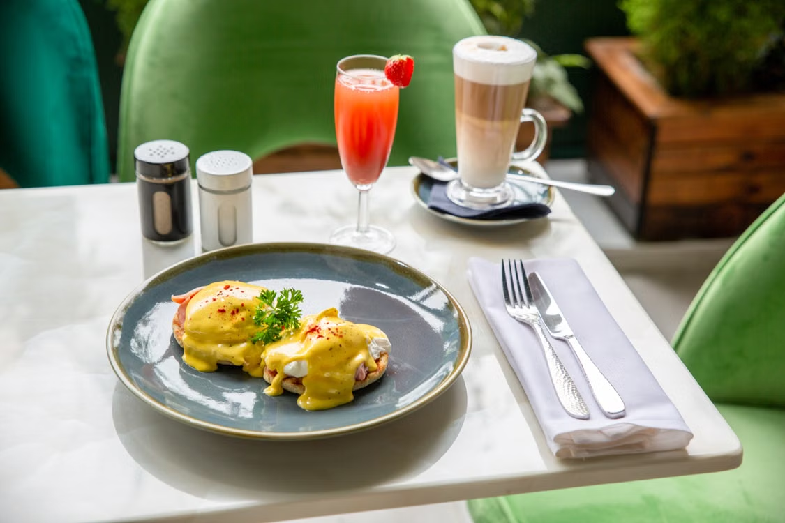 eggs benedict plated with hollandaise sauce