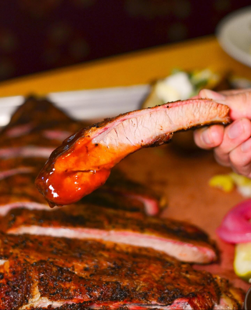Tender barbecue ribs served as a classic wood-smoked BBQ dish at Hick’ry Pit in Walnut Creek.