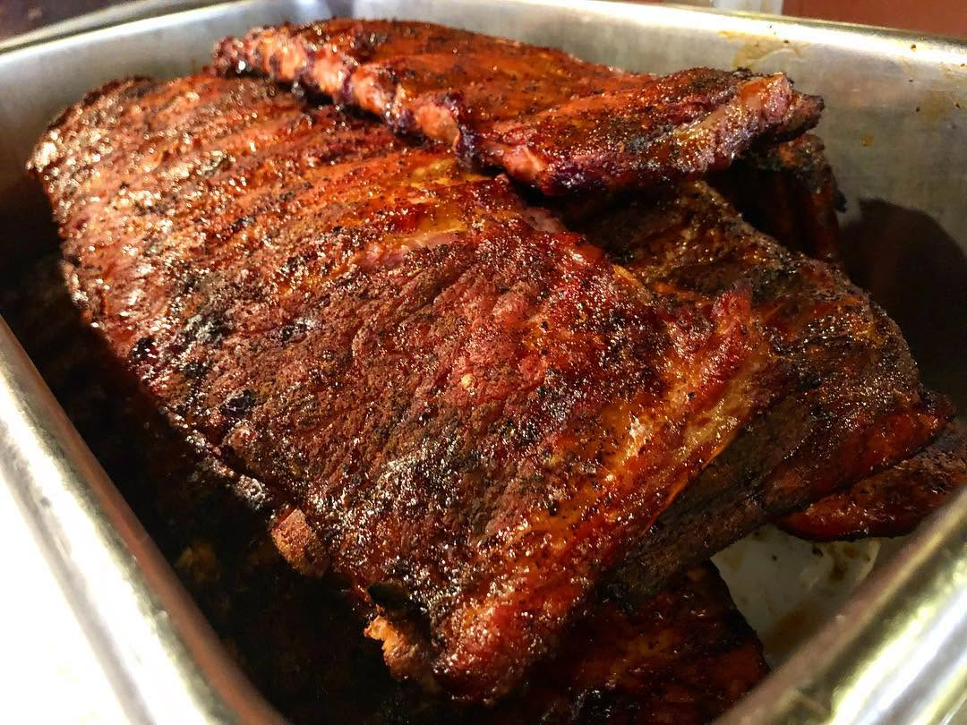St. Louis-style barbecue ribs prepared with Hick’ry Pit’s traditional wood-smoking method.
